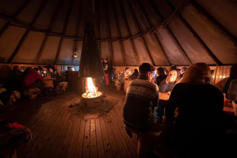 From Tromsø: Northern Lights Visit at Camp Tamok - The lávvu meal by an open fire